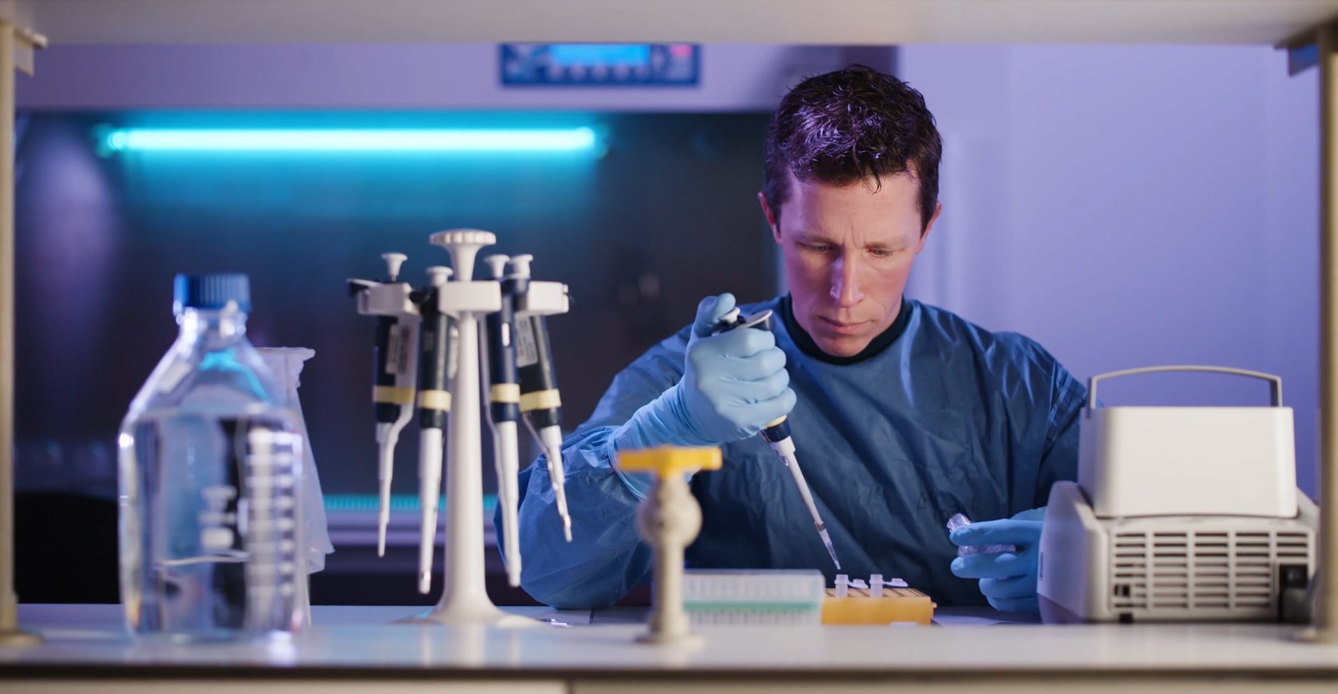 Male researcher working in a laboratory with a pipet
