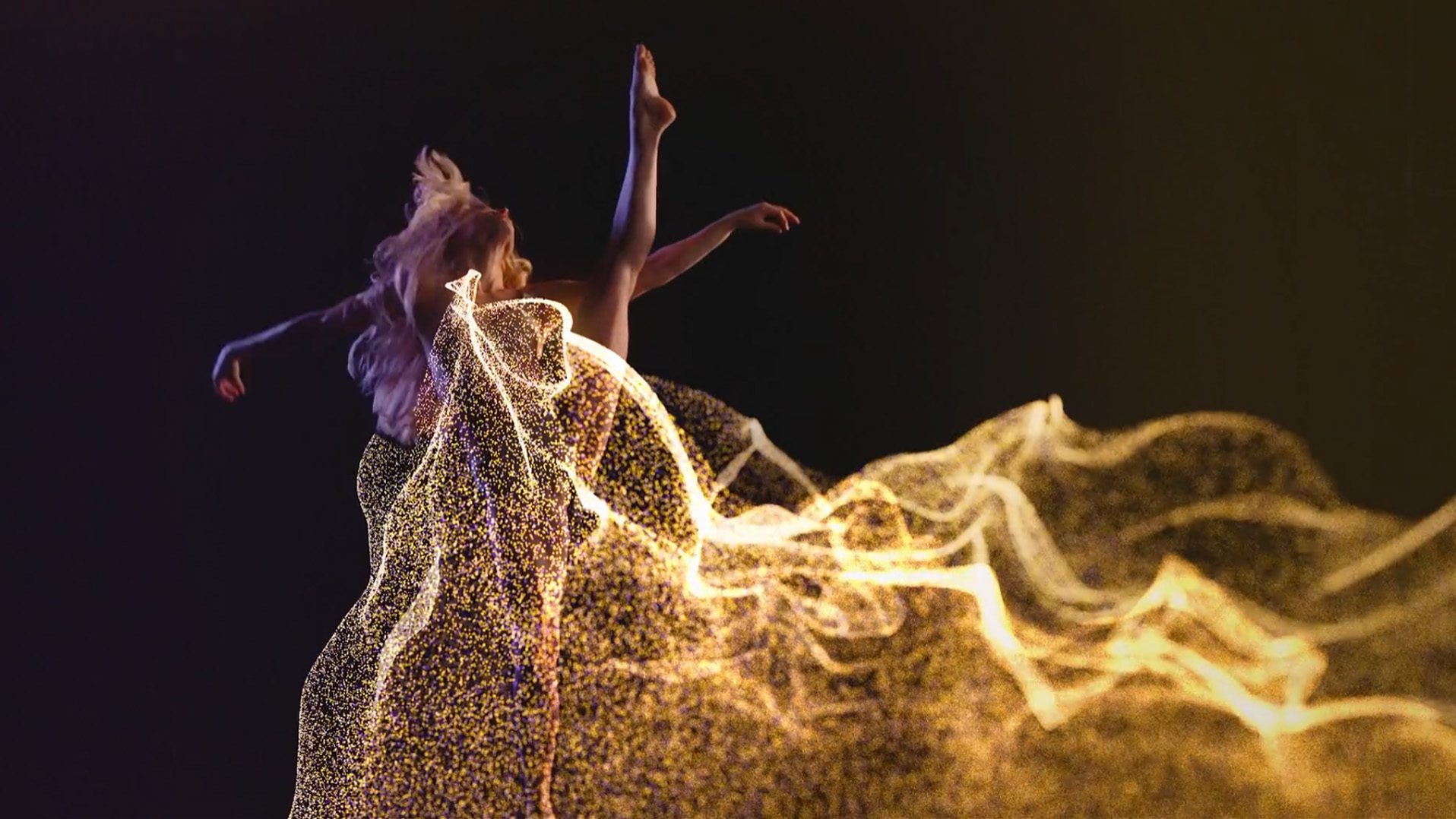 Dancer surrounded by a wave of golden particles