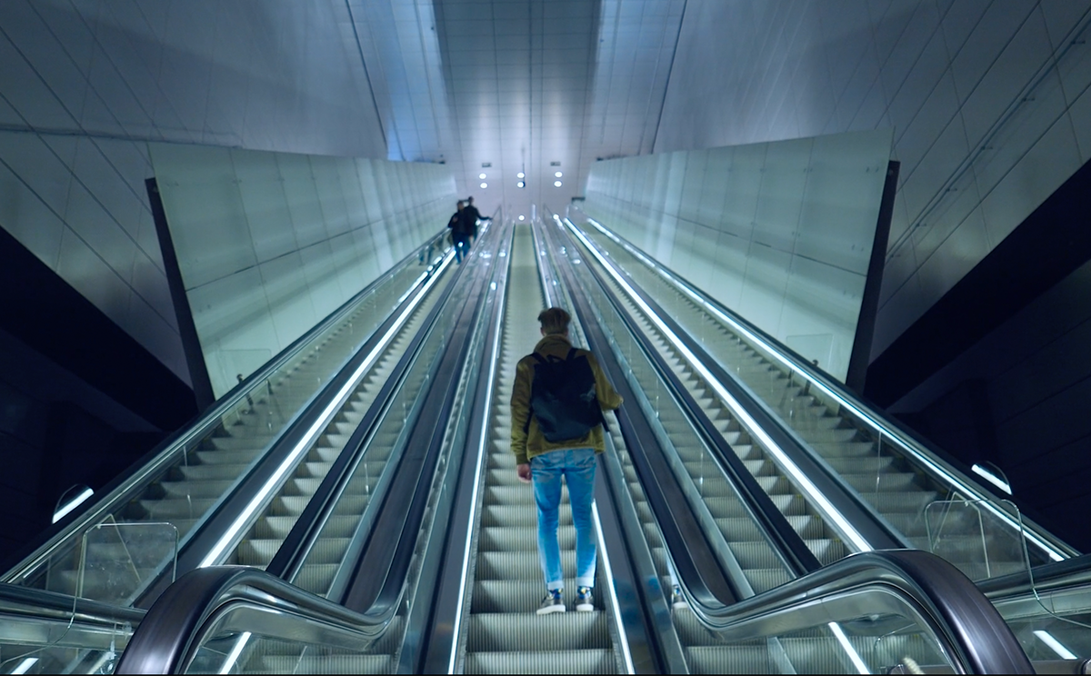Low angle shot of a person going up the elevator in a metro station