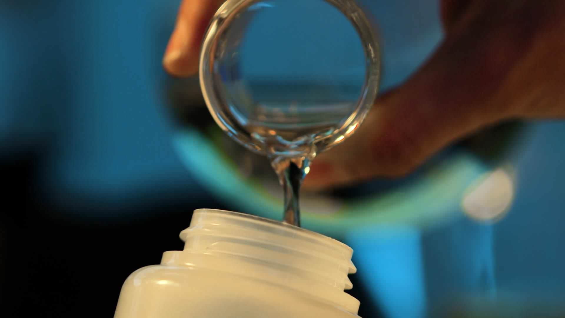 This image shows the pouring of fluid in a bottle for Magic Bullet film