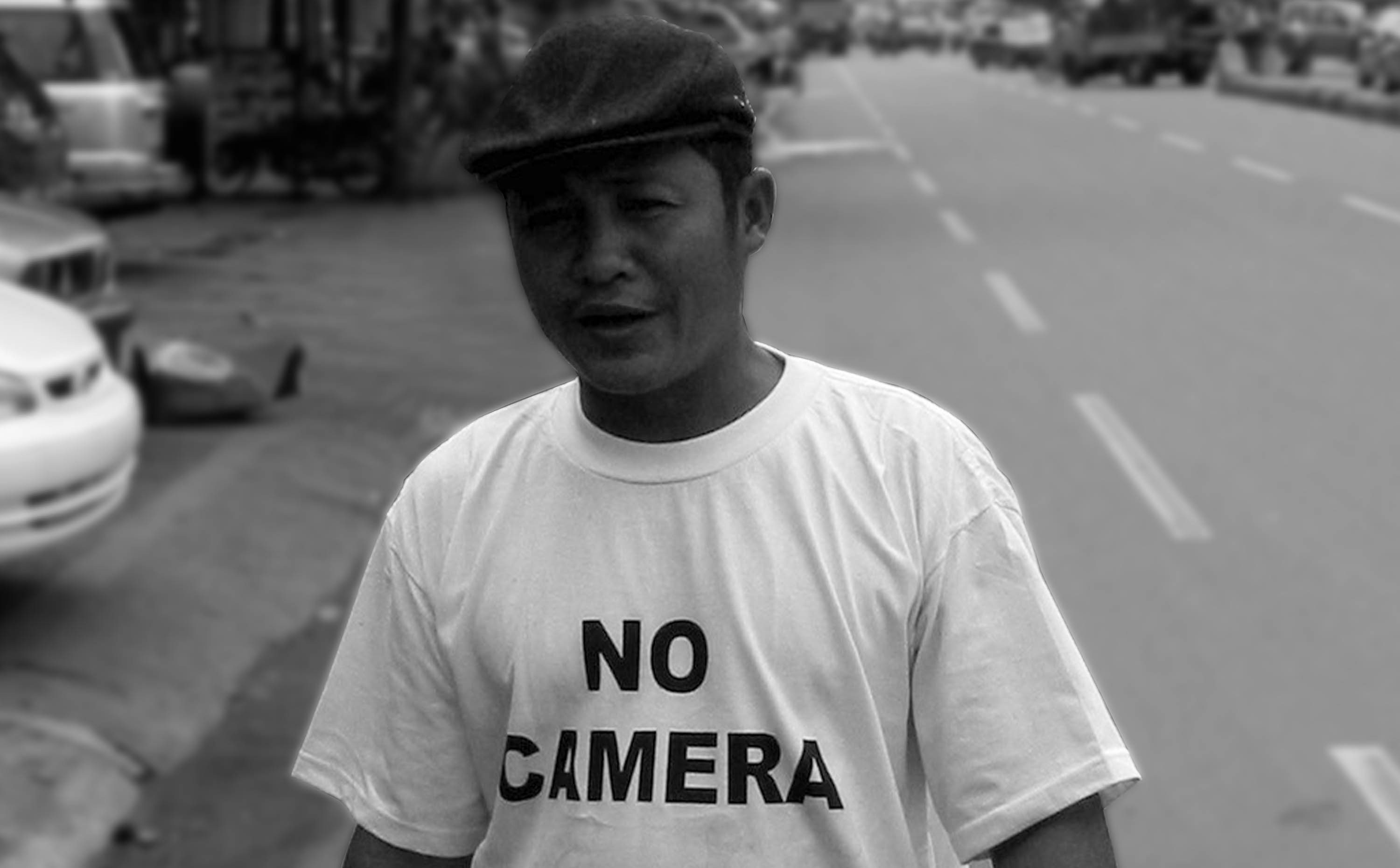 Cambodian man with a t-shirt that says No Camera
